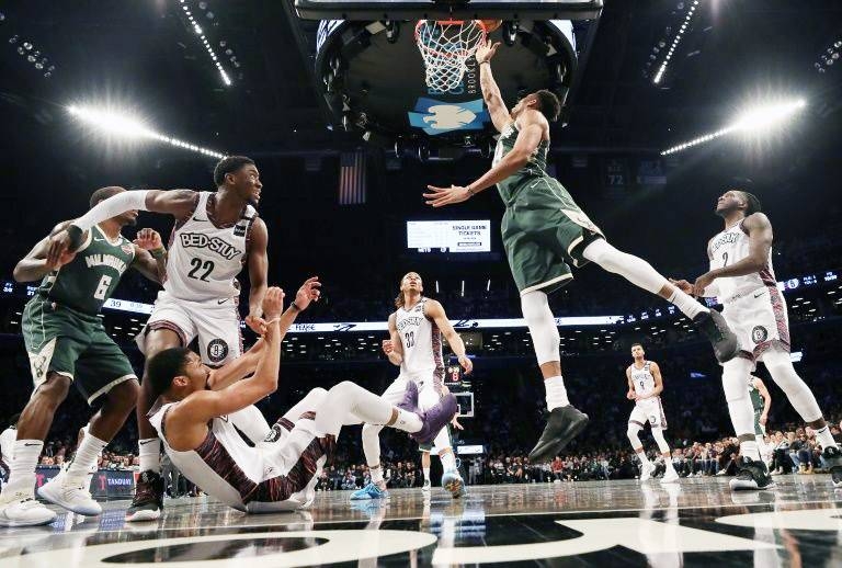 Milwaukee's NBA Most Valuable Player Giannis Antetokounmpo shoots against Brooklyn's Spencer Dinwiddie in a 117-97 victory over the Nets. — AFP