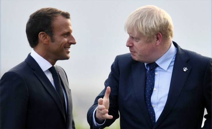 France's President Emmanuel Macron, left, and UK's Prime Minister Boris Johnson, right,  along with the world leaders were poised to commit to ending all foreign meddling in Libya's war at a Berlin summit Sunday.