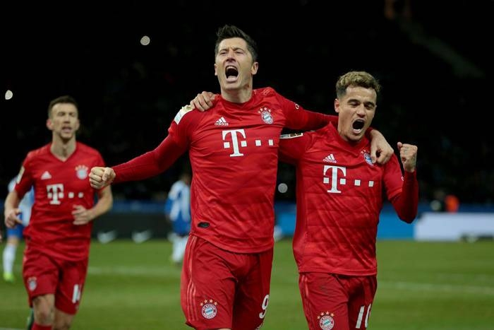 Lewandowski and Coutinho celebrate after a goal as Bayern Munich climbed to second in the Bundesliga Sunday with a 4-0 romp at Hertha Berlin to trim RB Leipzig's lead to four points. - AFP