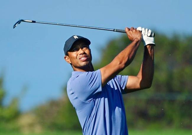 Tiger Woods watches a tee shot during Thursday's opening round of the US PGA Farmers Insurance Open at Torrey Pines North. — AFP