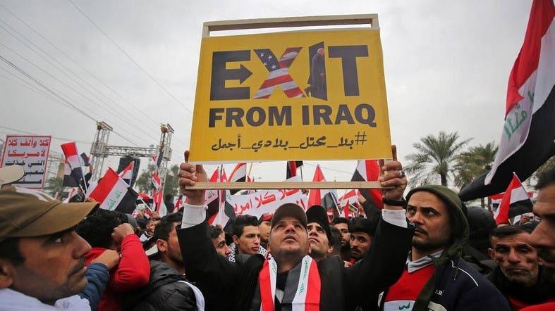 Protesters raise a placard as supporters of Iraqi cleric Moqtada Al-Sadr gather in the capital Baghdad for a 