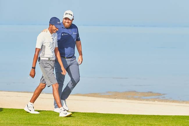 Saud AlSharif and Open champion Shane Lowry share a light moment during practice at the  Saudi International held at Royal Greens Golf Club, King Abdullah Economic City, Saudi Arabia.