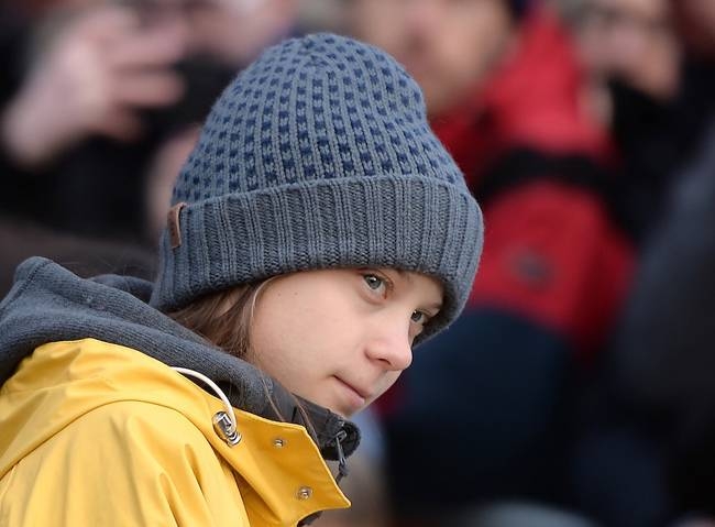 Swedish climate activist Greta Thunberg arrives to takes part at a Friday for Future strike on climate emergency, in Turin, on Dec. 13, 2019. — AFP