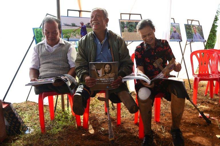 Vietnamese landmine victims, from left, Phan Van Ty, Truong Uu and Hoang Thi Luu read books in Quang Tri province, Vietnam, in this file photo. — AFP