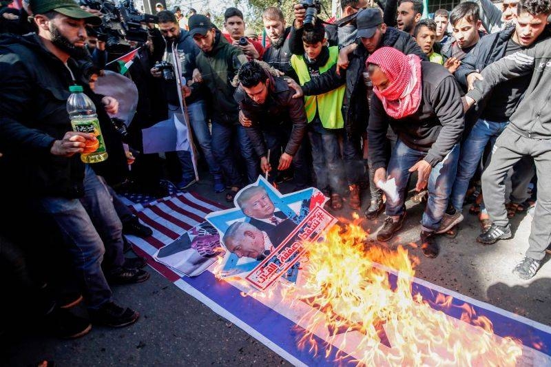 Palestinian demonstrators burn portraits of US President Donald Trump and Israeli Prime Minister Benjamin Netanyahu during a protest against Trump’s proposed peace plan in Gaza’s Jabalia refugee camp. — Courtesy photo