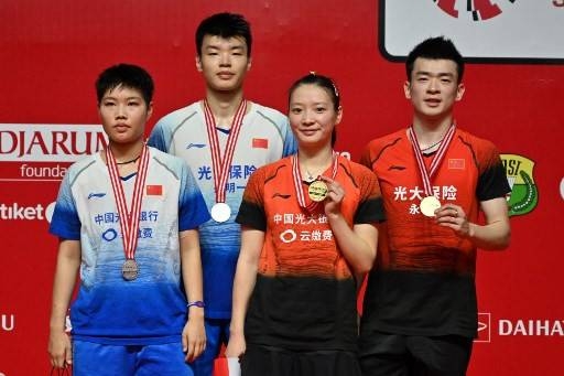 Gold medalists Zeng Shiwei, right, Huang Yaqiong, second right, of China and compatriot silver medalists Wang Yilyu, second left, and Huang Dongping, left, pose during their mixed doubles medal ceremony at the Indonesia Masters badminton tournament in Jakarta in this Jan. 19, 2020 file photo. — AFP