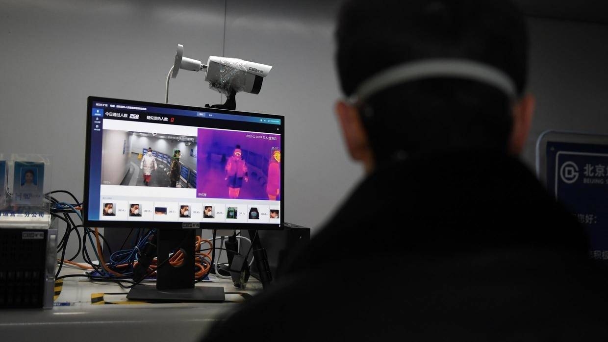 An AI-powered system developed by Megvii screens commuters for fever at a metro station in Beijing. — AFP 