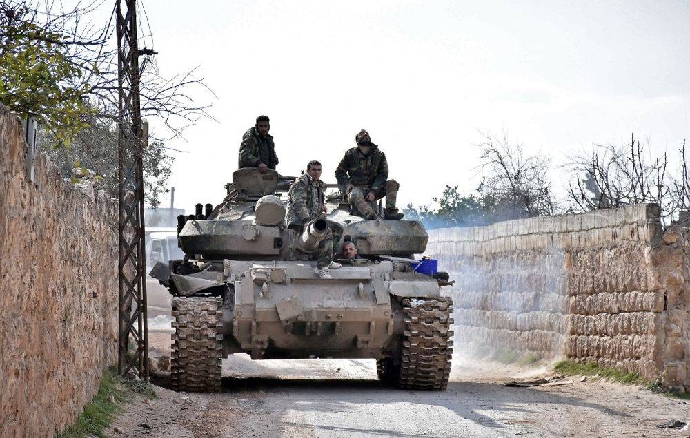 Handout picture released by the official Syrian Arab News Agency on Feb. 3, 2020, shows Syrian soldiers riding atop a T-27 tank in an area southwest of Saraqeb during their assault on Idlib region. — Courtesy picture