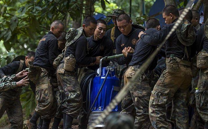 Thai soldiers carry equipment during rescue operations for 12 boys and their coach trapped in Tham Luang cave in Thailand in this July 4, 2018 file photo. — AFP