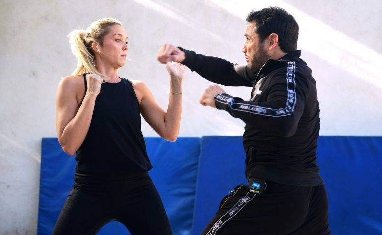 Stuntman Daniel Locicero, right, works out with actress Courtney M. Moore — he says an Oscar win for Brad Pitt for his role as a laid-back stuntman in 
