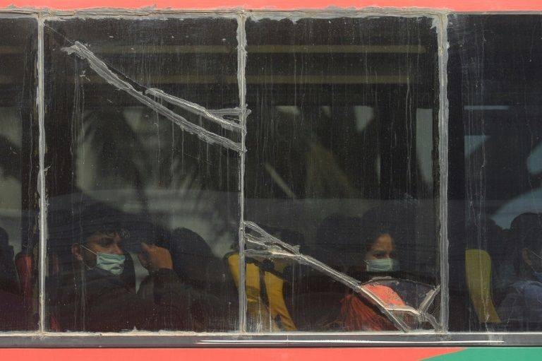 Bangladeshis evacuated on a first flight from Wuhan are taken by bus to quarantine. — AFP