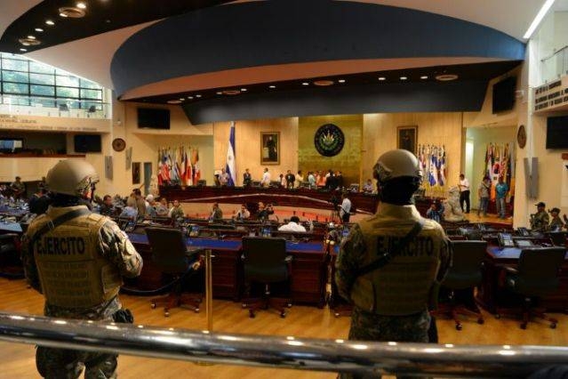 Before Mayib Bukele's entry, armed police and soldiers with rifles and wearing body armor entered the chamber. — AFP