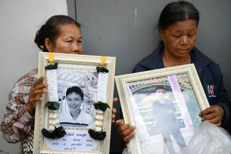 Holding portraits of their relatives and dabbing away tears, families of the victims of a mass shooting at the Terminal 21 shopping mall, arrived at a city morgue in Nakhon Ratchasima. — AFP