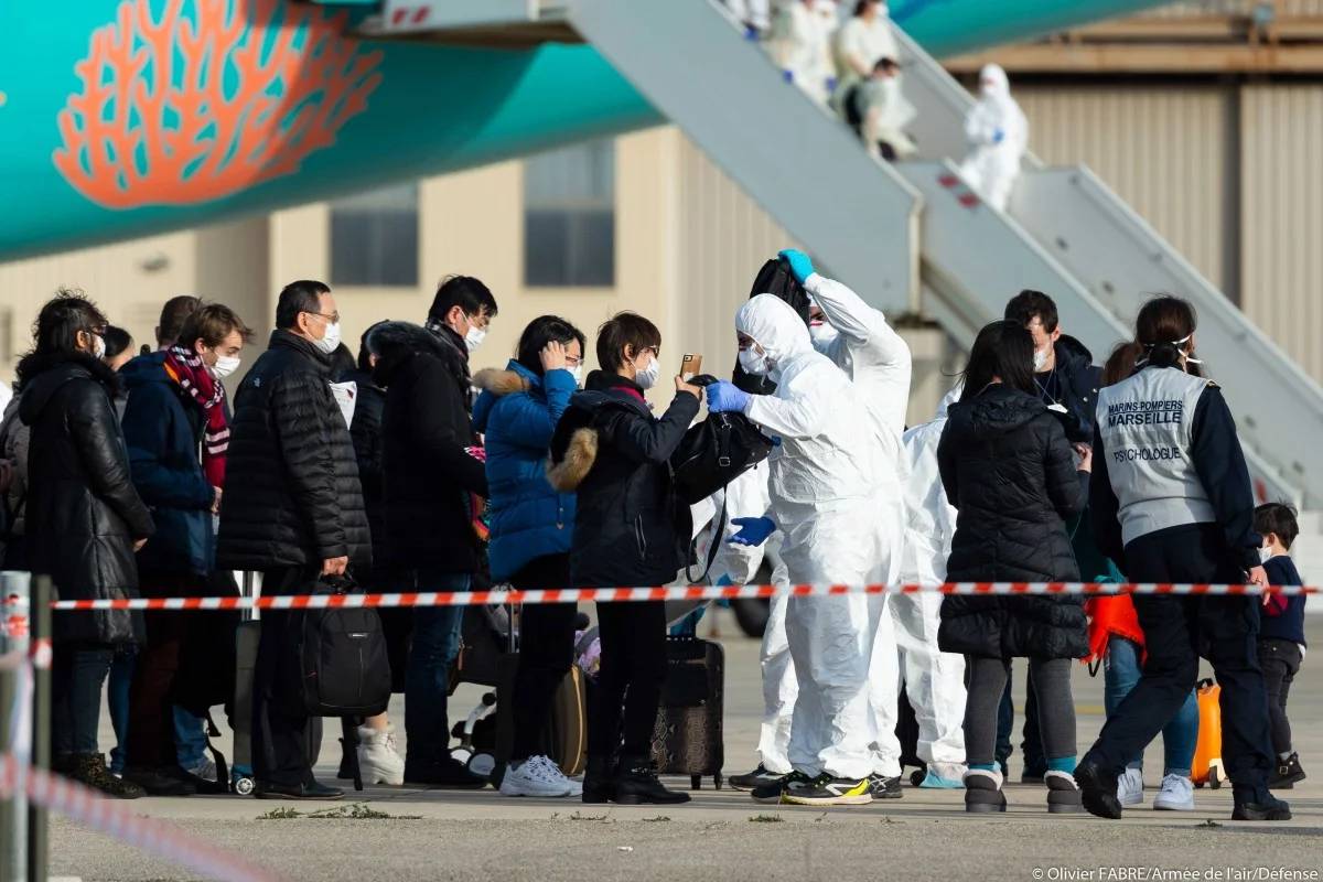 Passengers are being checked as they disembark from a plane carrying French citizens flown out of coronavirus epicenter Wuhan, upon their arrival at an air base in southeastern France, in this file photo. — AFP