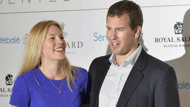 Britain's Peter Phillips and his wife Autumn pose for pictures upon arrival to attend the 'Sentebale Summer Party' in London in this May 7, 2014 file photo. — AFP