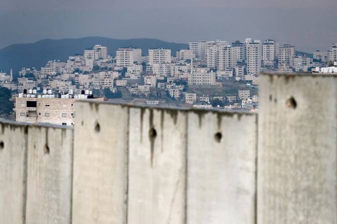 The occupied West Bank village of Al-Eizariya behind Israel's controversial separation barrier on the outskirts of East Jerusalem is seen in this Feb. 11, 2020 file photo. — AFP 