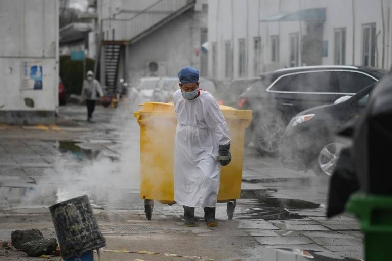 A worker moves medical waste at a hospital in Beijing treating coronavirus patients in this file photo. — AFP