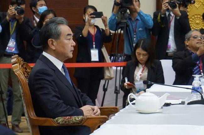 Chinese Foreign Minister Wang Yi (L) says his country's efforts to control the coronavirus outbreak are working. — AFP