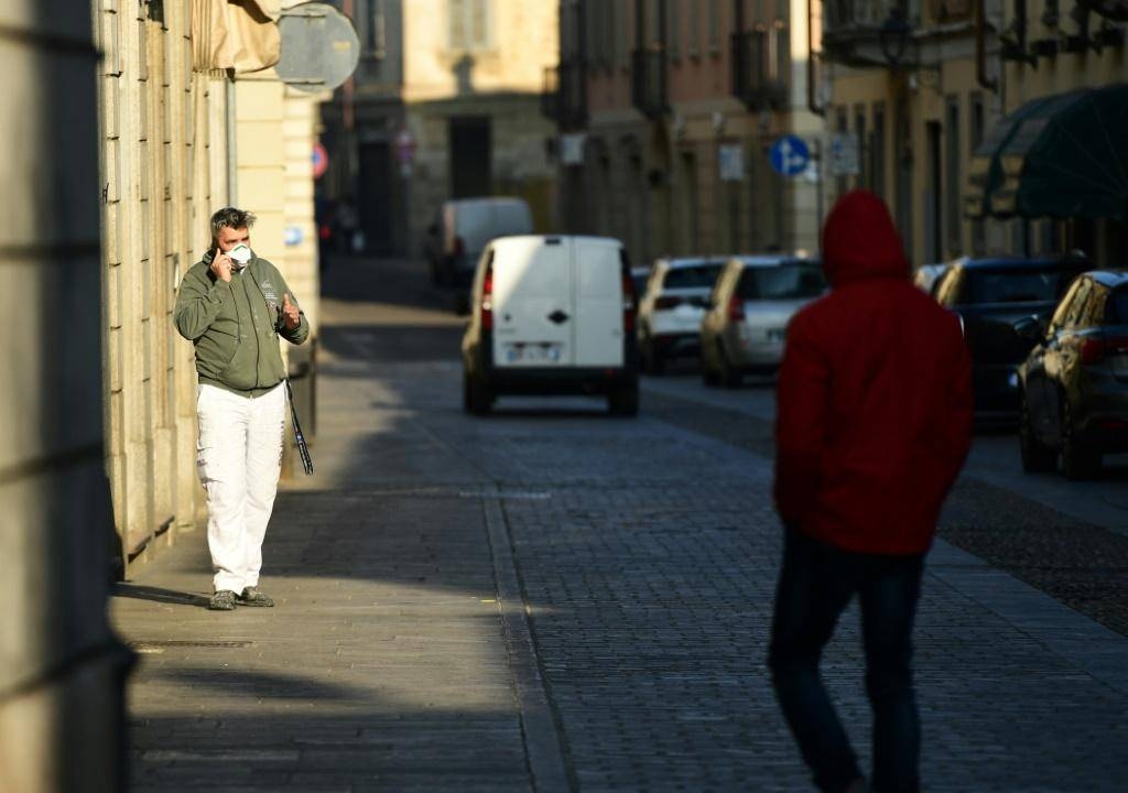 A resident wearing a protective mask in a street of Codogno, southeast of Milan. — AFP