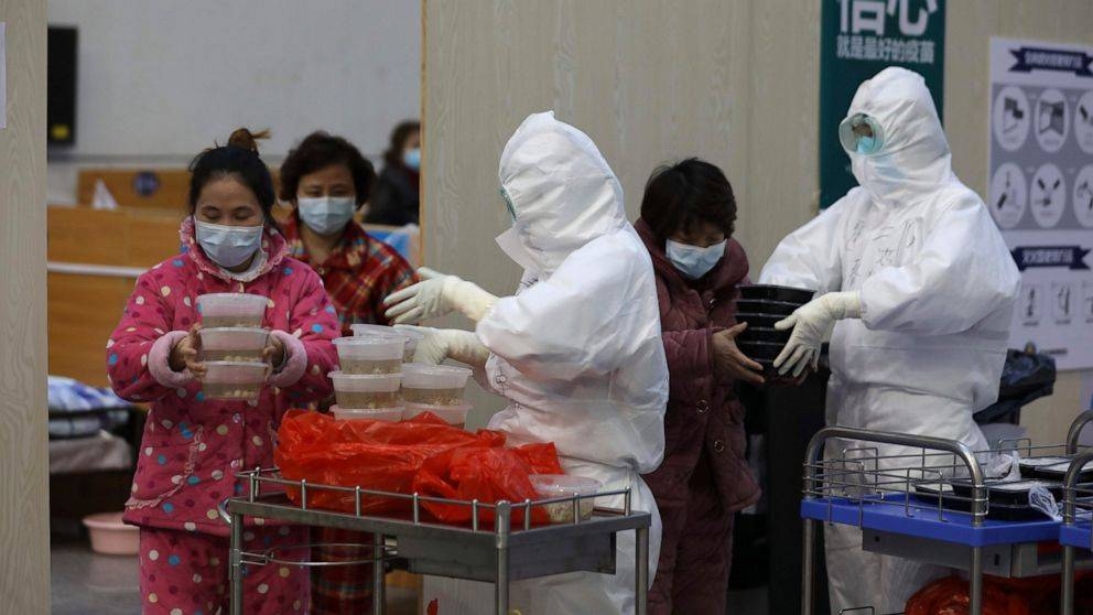 Nurses in protective suits distribute meals to patients at a temporary hospital at Tazihu Gymnasium in Wuhan in central China's Hubei province. — Courtesy photo