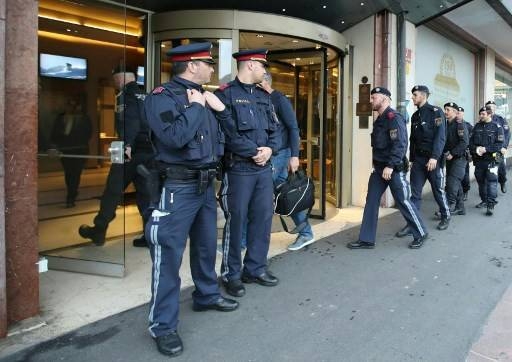 Police officers close a hotel near the city center in Innsbruck, Austria, on Tuesday after a woman who worked here has been confirmed infected with the coronavirus. — AFP