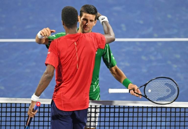 Novak Djokovic and Gael Monfils at the end of Friday's semi-final. — AFP