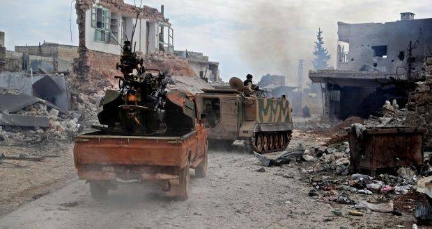 Members of the ‘Syrian National Army’, an alliance of Turkey-backed rebel groups, followed by a pickup truck mounted with an anti-aircraft gun ride in the town of Sarmin, about 8 km southeast of the city of Idlib, Syria. — Courtesy photo