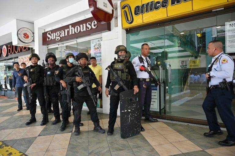 An official told journalists that a security guard was holding up to 30 people in an administrative office and had shot at least one person. — AFP