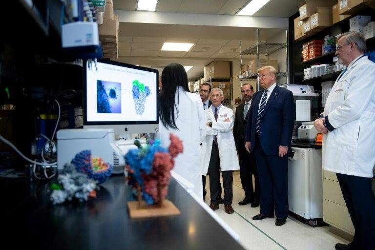President Donald Trump tours the National Institute of Health's Vaccine Research Center in Bethesda, Maryland, as the death toll in the US rose to nine, while infections passing 100. — AFP
