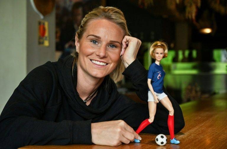 French international footballer Amandine Henry poses with a Barbie doll in her likeness. — AFP