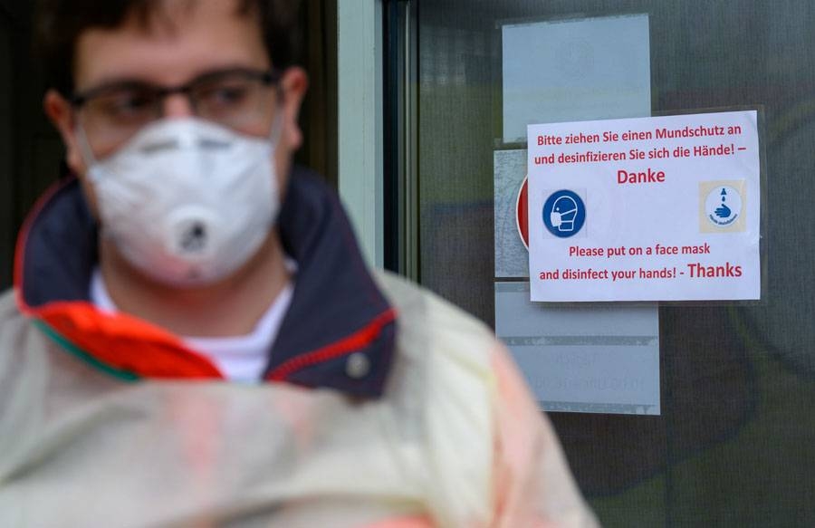 A Red Cross worker wearing a protective mask in Stuttgart, Germany, in this file picture. — Courtesy photo