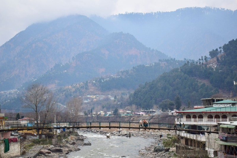 Pakistani residents walk on a bridge in the mountainous area of Balakot where the Indian Air Force (IAF) launched a raid, in this Feb. 26, 2019 file photo. — AFP
