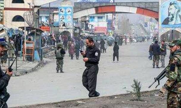 Afghan security forces personnel stand guard on a road near the site of a gun attack that occured during an event ceremony to mark the 25th anniversary of the death of Shiite leader Abdul Ali Mazari, in Kabul. — AFP
