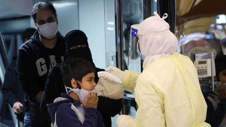 Passengers coming from China wearing masks to prevent coronavirus infection are checked by Saudi Health Ministry employees upon their arrival at Riyadh’s King Khalid International Airport. — Archives