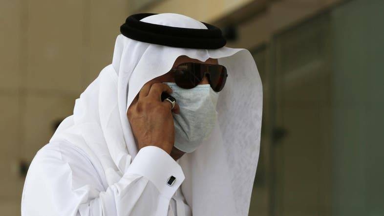 A Saudi man wears a mask and talks on his phone outside King Fahd hospital in Jeddah. — Archives