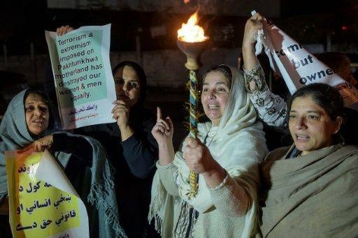 Civil society activists hold posters as they march to mark International Women's Day during a rally in Peshawar, Pakistan, on Sunday. — AFP