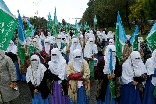 Civil society activists hold posters as they march to mark International Women's Day during a rally in Peshawar, Pakistan, on Sunday. — AFP