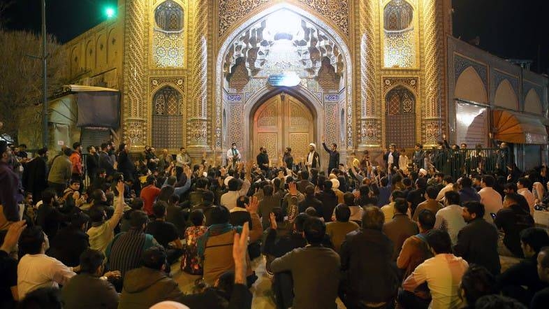 People gather outside the closed doors of the Fatima Masumeh shrine in the Shiite city of Qom, Monday. - Courtesy photo
