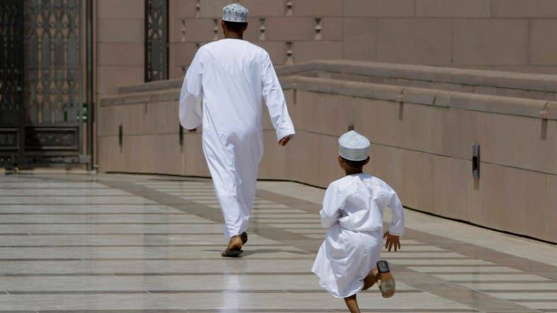 An Omani boy runs after his father as they rush for prayers at Sultan Qaboos Grand Mosque in Muscat. ‑‑ Courtesy photo
