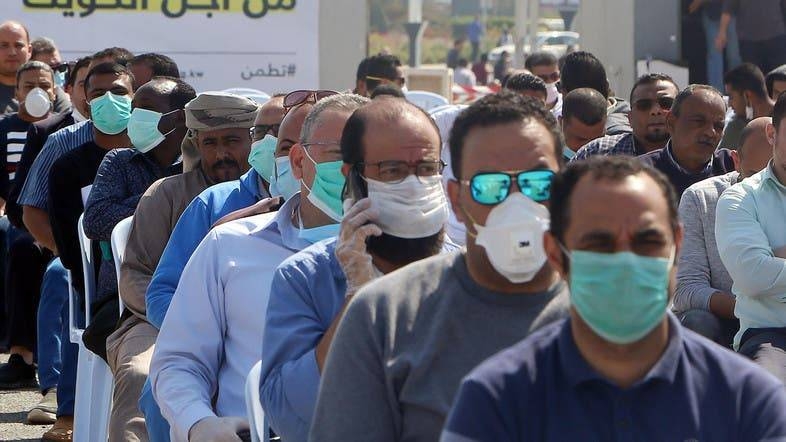 Expatriates returning from Egypt, Syria, and Lebanon arrive to be re-tested at a Kuwaiti health ministry containment and screening zone for the coronavirus in Kuwait City in this file photo. 