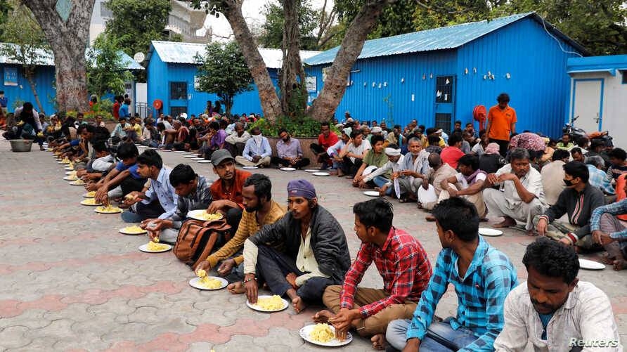

Daily wage workers and homeless people eat food inside a government-run night shelter during a 21-day nationwide lockdown to prevent the spread of coronavirus in the old quarters of Delhi, India, in this March 26, 2020 file picture. — Courtesy photo
