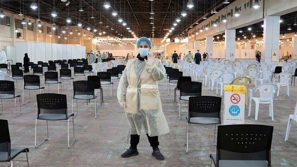 A volunteer, who directs visitors at a coronavirus testing center, gestures at the Kuwait International Fairgrounds in Mishref, Kuwait. -- Courtesy photo
