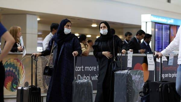 Travelers wear masks as they arrive at Dubai International Airport in this file photo
