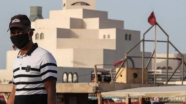 A man wearing a mask walks along the Doha corniche near the Qatar Islamic Museum in this file picture. — Courtesy photo