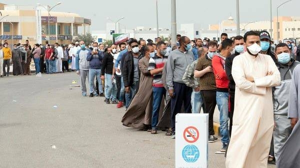 
Expatriates wait in line to be tested at a makeshift center, following the outbreak of coronavirus, in Mishref, Kuwait, in this file picture. — Courtesy photo