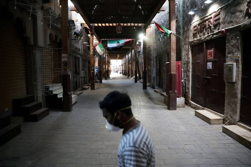  A man wearing a protective face mask walks through the deserted Barajeel Souq in old Dubai in this file picture. — Courtesy photo 
