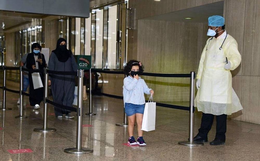 Saudi citizens, who arrived at King Fahd International Airport in Dammam from Kuala Lumpur on Saturday, form a queue before completing the formalities.
