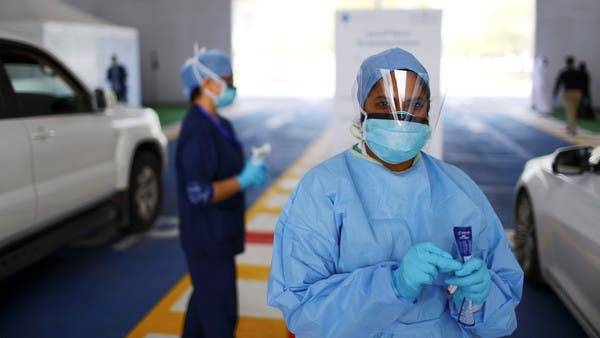 A member of medical staff looks on during drive-thru coronavirus testing in Abu Dhabi. -- File photo
