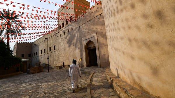 A man walks past the walls of the Nizwa Fort in Oman. -- Courtesy photo
