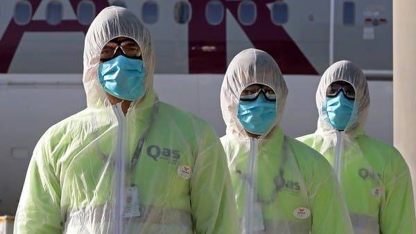 Employees of Qatar Aviation Services (QAS), wearing protective gear as a safety measure during the COVID-19 coronavirus pandemic, walk along the tarmac after sanitizing an aircraft at Hamad International Airport in the Qatari capital Doha. -- Courtesy photo